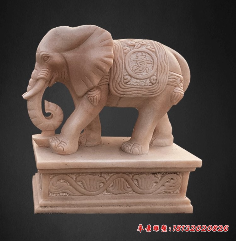 晚霞红招财大象石雕鼻卷元宝的大象石雕 